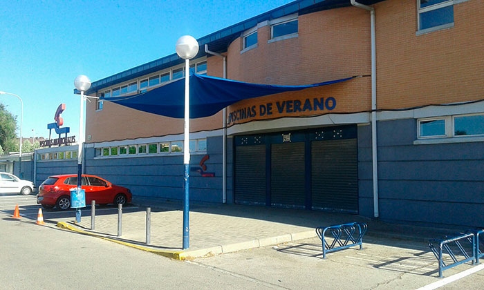 Lona instalada en la entrada de la piscina de verano.